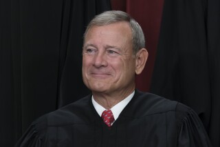 FILE - Chief Justice of the United States John Roberts joins other members of the Supreme Court as they pose for a new group portrait, at the Supreme Court building in Washington, Friday, Oct. 7, 2022. (AP Photo/J. Scott Applewhite, File)