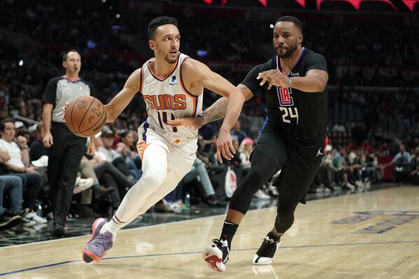 Phoenix Suns guard Landry Shamet, left, drives past Los Angeles Clippers forward Norman Powell during the second half of an NBA basketball game Wednesday, April 6, 2022, in Los Angeles. (AP Photo/Mark J. Terrill)