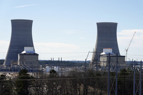 FILE - Units 3, left, and 4 and their cooling towers stand at Georgia Power Co.'s Plant Vogtle nuclear power plant, Jan. 20, 2023, in Waynesboro, Ga. Residential customers of Georgia's largest electrical utility could see their bills rise another $9 a month to pay for a new nuclear power plant under a deal announced Wednesday, Aug. 30. Georgia Power Co. said customers would pay $7.56 billion more for Plant Vogtle construction costs under the agreement with utility regulatory staff. (AP Photo/John Bazemore, File)