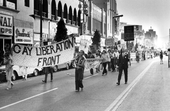 FILE - Demonstrators carry signs down Hollywood Boulevard calling to end the discrimination on June 29, 1970, in Hollywood, Calif.  (AP Photo/File)