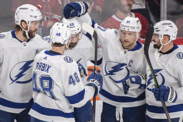 Tampa Bay Lightning's Nicholas Paul (20) celebrates with teammates after scoring against the Montreal Canadiens during first-period NHL hockey game action in Montreal, Saturday, Dec. 17, 2022. (Graham Hughes/The Canadian Press via AP)