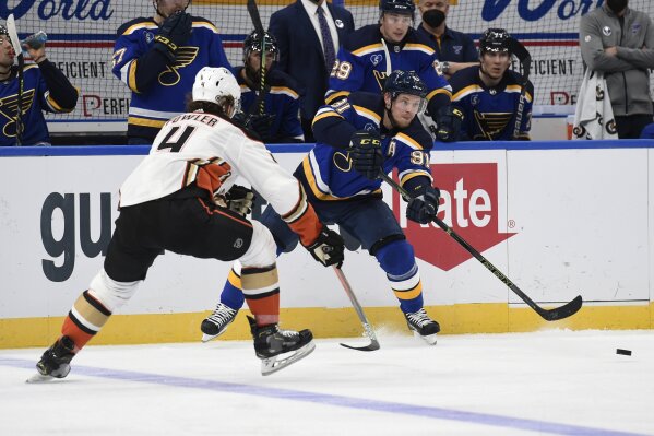 Anaheim Ducks' Cam Fowler (4) attempts to block a pass from St. Louis Blues' Vladimir Tarasenko (91) during the second period of an NHL hockey game Friday, March 26, 2021, in St. Louis. (AP Photo/Joe Puetz)