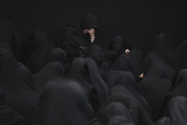 Women attend the Ashoura mourning ritual, Friday, July 28, 2023, in Tehran, Iran. Millions of Shiite Muslims around the world on Friday commemorated Ashoura, a remembrance of the 7th-century martyrdom of the Prophet Muhammad's grandson, Hussein, that gave birth to their faith. (AP Photo/Vahid Salemi)
