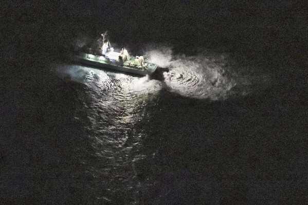 A Japan Coast Guard vessel conducts a search and rescue operation around the site of a U.S. military Osprey aircraft believed to have crashed in the sea off Yakushima Island, Kagoshima Prefecture, southern Japan, Wednesday, Nov. 29, 2023.  and debris in the sea after a US military Osprey plane carrying eight people crashed off southern Japan on Wednesday, officials said.  (Kyoto News via AP)