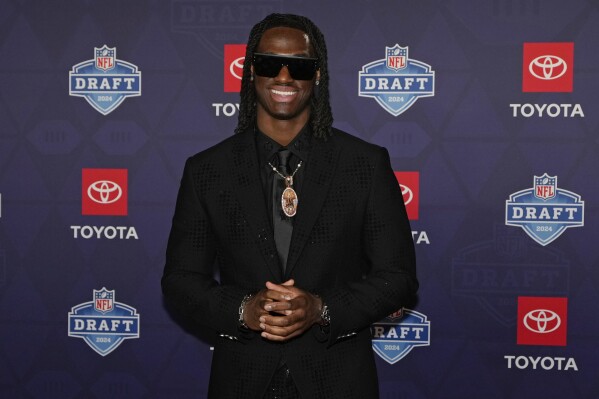 Ohio State wide receiver Marvin Harrison Jr. poses on the red carpet ahead of the first round of the NFL football draft, Thursday, April 25, 2024, in Detroit. (AP Photo/Carlos Osorio)