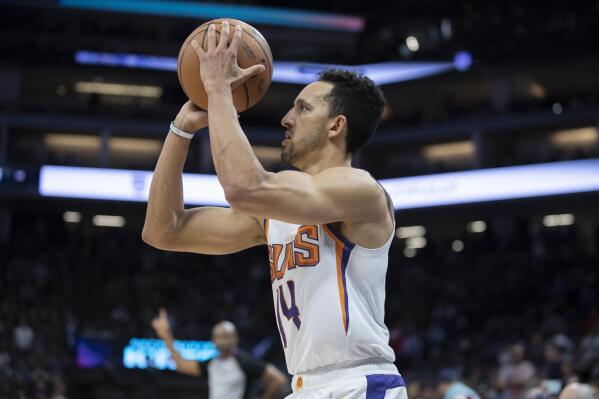 Phoenix Suns guard Landry Shamet (14) shoots and scores a three point shot late in overtime of an NBA basketball game against the Sacramento Kings in Sacramento, Calif., Sunday, March 20, 2022. The Suns won 127-124.(AP Photo/José Luis Villegas)