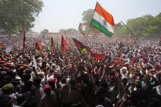 Supporters of Samajwadi Party and Indian National Congress shout slogans and wave flags at an election rally by Indian National Developmental Inclusive Alliance (INDIA) leaders Rahul Gandhi and Akhilesh Yadav in Prayagraj, Uttar Pradesh, India, Sunday, May 19, 2024. (AP Photo/Rajesh Kumar Singh)