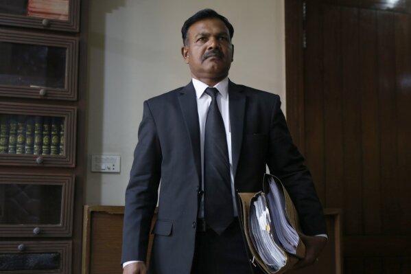 Naseeb Anjum, a lawyer for Nabeel Masih, a Christian man convicted while still a teenager in 2018 of blasphemy, arrives for an interview with The Associated Press, in Lahore, Pakistan, Monday, March 1, 2021. Anjum said a Pakistani court granted bail to Masih convicted of insulting Islam by posting a picture of Islam’s holiest site on social media. (AP Photo/K.M. Chaudary)