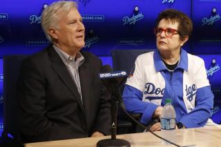FILE -Los Angeles Dodgers owner & chairman Mark Walter, left, introduces to the baseball team ownership group, tennis champion Billie Jean King at a news conference in Los Angeles, Friday, Sept. 21, 2018. North America’s top women’s hockey players are teaming up with former tennis star Billie Jean King and Los Angeles Dodgers chairman Mark Walter to explore launching a pro league within the next year, a person with direct knowledge of the agreement told The Associated Press on Tuesday night, May 24, 2022. (AP Photo/Alex Gallardo, File)