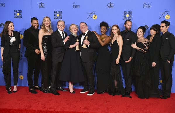 The cast and crew of "The Handmaid's Tale" pose in the press room with the award for best television series - drama at the 75th annual Golden Globe Awards at the Beverly Hilton Hotel on Sunday, Jan. 7, 2018, in Beverly Hills, Calif. (Photo by Jordan Strauss/Invision/AP)