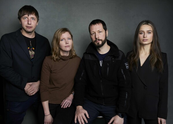 FILE - Photographer Evgeniy Maloletka, from left, "Frontline" producer/editor Michelle Mizner, director Mstyslav Chernov, and field producer Vasilisa Stepanenko pose for a portrait to promote the film "20 Days in Mariupol" at the Latinx House during the Sundance Film Festival on Sunday, Jan. 22, 2023, in Park City, Utah. The film is a joint project between The Associated Press and PBS "Frontline." (Photo by Taylor Jewell/Invision/AP, File)