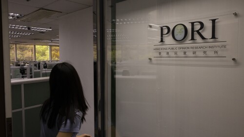 An employee of the Hong Kong Opinion Research Institute (PORI) enters the office in Hong Kong, Wednesday, June 21, 2023. A Hong Kong pollster is planning to cancel part of its regular survey questions weeks after the release of its report about the anniversary of China’s crackdown 1989 pro-democracy protests was canceled due to the government’s risk assessment.(AP Photo/Louise Delmotte)