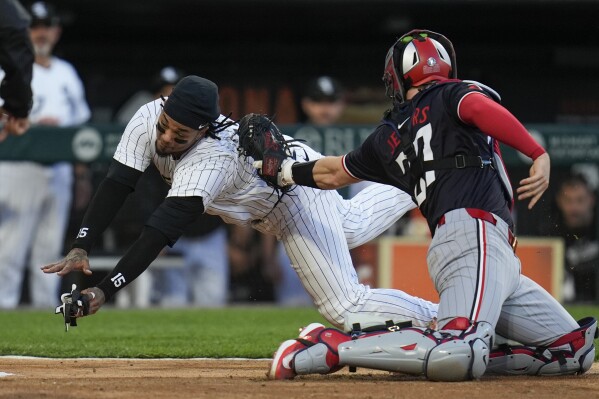 Martin Maldonado of the Chicago White Sox is tagged home by Minnesota Twins catcher Ryan Jeffers during the bottom of the third inning of a baseball game Tuesday, April 30, 2024, in Chicago.  (AP Photo/Erin Hooley)