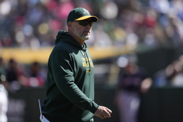 Oakland Athletics manager Mark Kotsay walks to the dugout after making a pitching change during the eighth inning of the team's baseball game against the Cleveland Guardians in Oakland, Calif., Sunday, March 31, 2024. (AP Photo/Jeff Chiu)