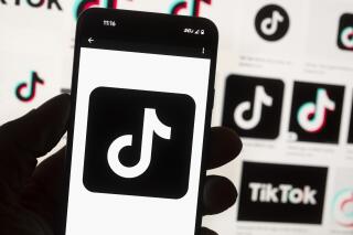 FILE - The TikTok logo is seen on a cell phone on Oct. 14, 2022, in Boston. The White House is giving all federal agencies 30 days to wipe TikTok off all government devices, as the Chinese-owned social media app comes under increasing scrutiny in Washington over security concerns. (AP Photo/Michael Dwyer, File)