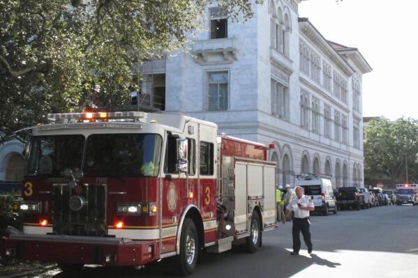 A firetruck sits outside the historic federal courthouse on Tuesday, April 11, 2023, in Savannah, Ga., after part of an upper floor collapsed and injured three construction workers. The U.S. government building, which dates to 1899, has been undergoing extensive renovations for more than a year. (AP Photo/Russ Bynum)