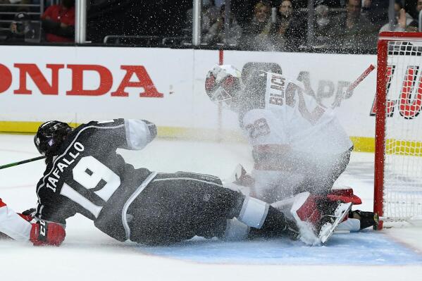 Los Angeles Kings right wing Alex Iafallo (19) collides with New Jersey Devils goaltender Mackenzie Blackwood (29) during the second period of an NHL hockey game Friday, Nov. 5, 2021, in Los Angeles. (AP Photo/John McCoy)