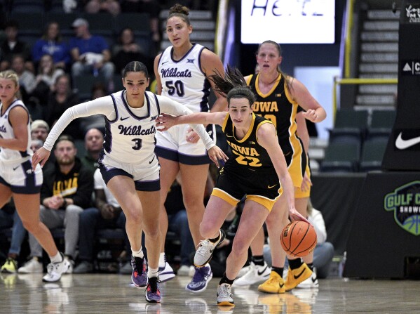 Caitlin Clark (22) fights for a loose ball over Kansas State Jaelyn Glenn (3) during the final game of the NCAA college basketball Gulf Coast Showcase, Sunday, Nov. 26, 2023, in Estero, Fla. (AP Photo/Chris Tilley)
