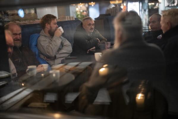 Trond Johansen, 70, and fellow retired miners gather for coffee at a coffee shop in Longyearbyen, Norway, Thursday, Jan. 12, 2023. (AP Photo/Daniel Cole)