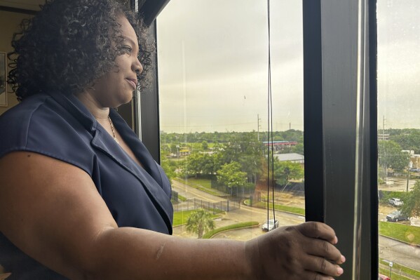 Louisiana Democratic state Rep. Delisha Boyd looks out the window at her office May 3, 2024, in New Orleans. As Boyd faces an uphill battle in Louisiana, as she attempts to advance a bill that would add cases of rape and incest as exceptions to Louisiana's near total abortion ban, the Democrat opens opening up about her mother's harrowing story and how it effected them. (AP Photo/Stephen Smith)