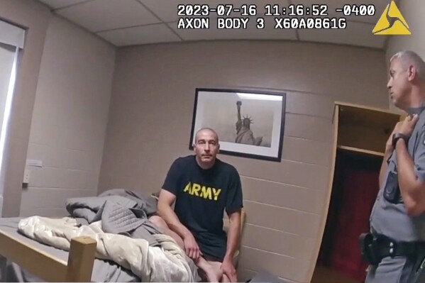 In this image taken from New York State Police body camera video that was obtained by WMTW-TV 8 in Portland, Maine, New York State police interview Army Reservist Robert Card, the man responsible for Maine's deadliest mass shooting, at Camp Smith in Cortlandt, New York on July 16, 2023. Card told state police before being hospitalized that fellow soldiers were worried about him because he was ”gonna friggin' do something,” according to police body cam video released under New York's Freedom of Information Law. Card went on to kill 18 people and wounded 13 at a bowling alley and a bar in Lewiston, Maine, leading to the largest manhunt in state history and tens of thousands of people sheltering in their homes. Card's body was found two days later. He had died by suicide. (WMTW-TV 8/New York State police via AP)