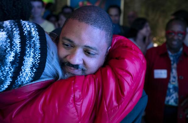 Alvin Bragg, a former top deputy to New York's attorney general, is embraced after speaking to supporters in New York, late Tuesday, June 22, 2021. (AP Photo/Craig Ruttle)