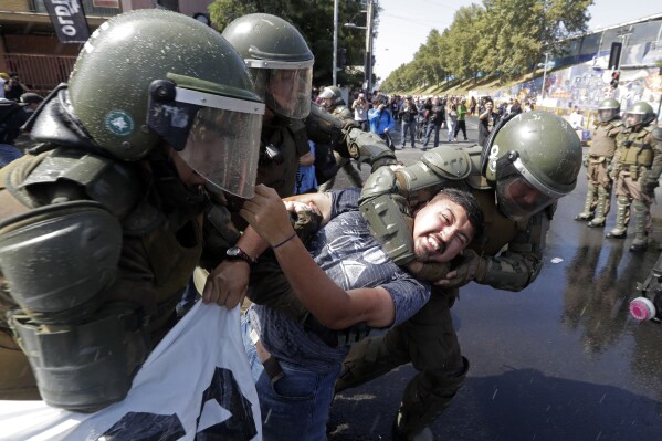 A man is arrested during a protest against Pope Francis and the Vatican’s handling of sex abuse cases in Santiago, Chile, Jan. 16, 2018. (AP Photo/Victor R. Caivano)