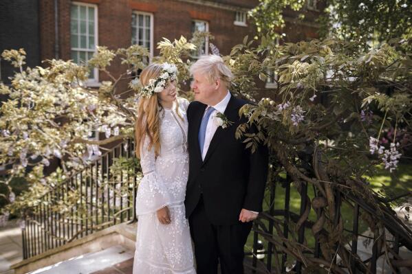 In this image released Sunday May 30, 2021, by Downing Street, Britain's Prime Minister Boris Johnson and Carrie Johnson pose together for a photo in the garden of 10 Downing Street after their wedding on Saturday. Boris Johnson and his fiancée Carrie Symonds are newlyweds, according to an announcement from his Downing Street office saying they were married Saturday in a small private ceremony in London. (Rebecca Fulton/Downing Street via AP)