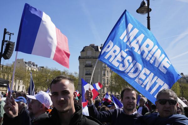People attend at the French far-right party national rally near the parliament in support of Marine Le Pen, in Paris, Sunday, April 6, 2025. (AP Photo/Michel Euler)