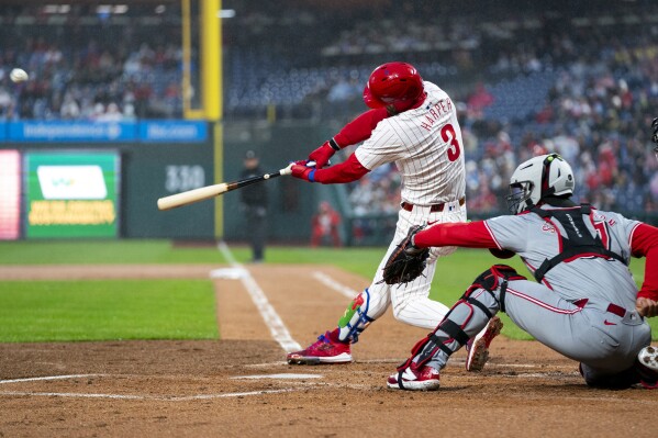 Philadelphia Phillies' Bryce Harper hits a solo home run during the first inning of a baseball game against the Cincinnati Reds, Tuesday, April 2, 2024, in Philadelphia. (AP Photo/Chris Szagola)