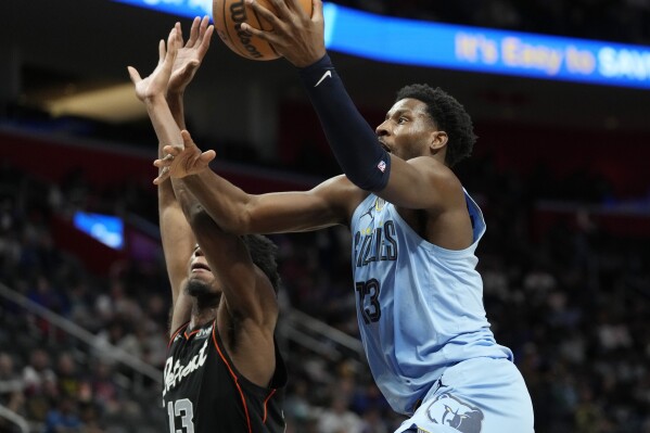 Memphis Grizzlies forward Jaren Jackson Jr. (13) is defended by Detroit Pistons center James Wiseman (13) during the first half of an NBA basketball game, Monday, April 1, 2024, in Detroit. (AP Photo/Carlos Osorio)