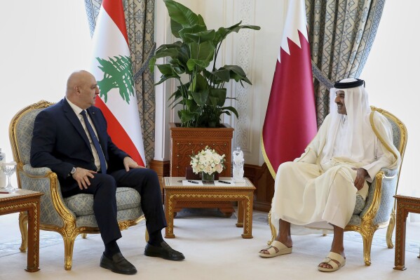 In this photo released by the Lebanese Presidency press office, Emir of Qatar Sheikh Tamim bin Hamad Al Thani, right, and Lebanese President Joseph Aoun meet in Doha, Qatar, Wednesday, April 16, 2025. (Lebanese Presidency press office via AP)