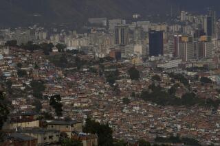 Cinderblock homes cover a poor neighborhood, known as a "barrio," in Caracas, Venezuela, Wednesday, March 1, 2023. (AP Photo/Ariana Cubillos)
