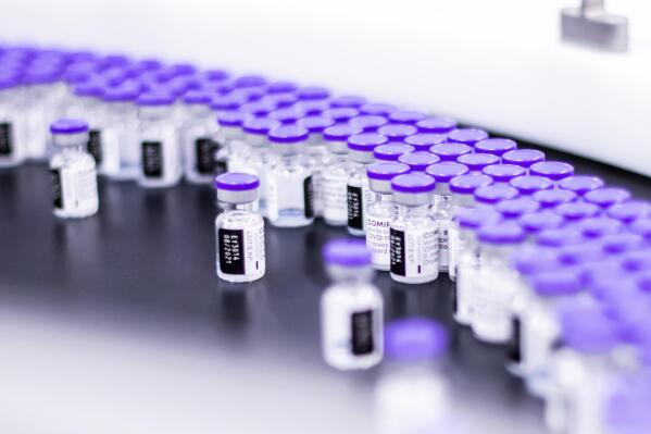 In this March 2021 photo provided by Pfizer, vials of the Pfizer-BioNTech COVID-19 vaccine are prepared for packaging at the company’s facility in Puurs, Belgium. Pfizer is about to seek U.S. authorization for a third dose of its COVID-19 vaccine, saying Thursday, July 8, 2021, that another shot within 12 months could dramatically boost immunity and maybe help ward off the latest worrisome coronavirus mutant. (Pfizer via AP)