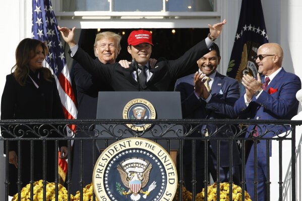 President Donald Trump, left, reacts as Washington Nationals catcher Kurt  Suzuki walks to a podium to speak during an event to honor the 2019 World  Series champion Nationals at the White House