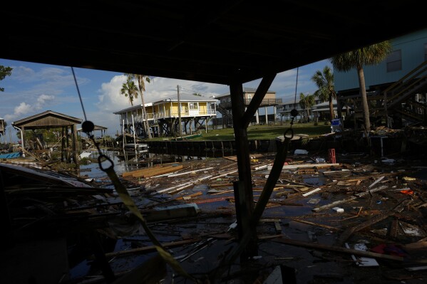 Debris from destroyed homes and structures floats in a canal in Horseshoe Beach, Fla., Aug. 31, 2023, one day after the passage of Hurricane Idalia. (AP Photo/Rebecca Blackwell, File)