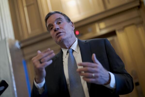 FILE - Sen. Mark Warner, D-Va., chair of the Senate Intelligence Committee, pauses to speak with reporters at the Capitol in Washington, Nov. 10, 2022. Members of the Senate intelligence committee say they should have access to classified documents that were discovered in the homes of President Joe Biden, former President Donald Trump and former Vice President Mike Pence.(AP Photo/J. Scott Applewhite, File)