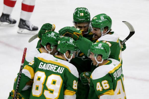 Minnesota Wild center Frederick Gaudreau (89) is congratulated by teammates Jared Spurgeon (46), Marcus Foligno (17), Jordan Greenway (18) and Sam Steel (13) after scoring a goal in the first period of an NHL hockey game against the Detroit Red Wings Wednesday, Dec. 14, 2022, in St. Paul, Minn. (AP Photo/Andy Clayton-King)