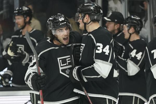Los Angeles Kings defenseman Sean Durzi (50) celebrates with left wing Arthur Kaliyev (34) after Kaliyev scored a goal during the third period of an NHL hockey game against the Dallas Stars Thursday, Dec. 9, 2021, in Los Angeles. (AP Photo/Ashley Landis)