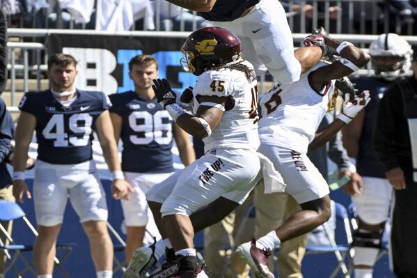 Penn State tight end Brenton Strange (86) hurdles Central Michigan defenders Lavario Wiley (6) and Justin Whiteside (45) during the first half of an NCAA college football game, Saturday, Sept. 24, 2022, in State College, Pa. (AP Photo/Barry Reeger)