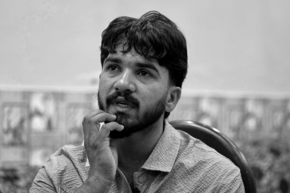 Amir Ali, who survived a failed attempt to reach Spain by boat, recounts his story during an interview with The Associated Press in Dera Bajwa, a village in Gujranwala district, Pakistan, April 23, 2025. (AP Photo/Anjum Naveed)