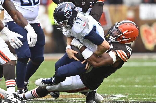 Tennessee Titans quarterback Ryan Tannehill (17) is sacked by Cleveland Browns defensive end Myles Garrett, right, during the first half of an NFL football game Sunday, Sept. 24, 2023, in Cleveland. (AP Photo/David Richard)