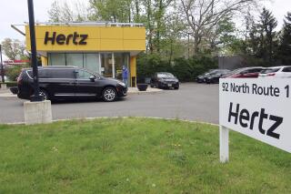 FILE - In this May 6, 2020, file photo, a Hertz car rental is closed during the coronavirus pandemic in Paramus, N.J.  Two investment firms are looking to take at least a controlling stake in rental car company Hertz for up to $4.2 billion and help it emerge from bankruptcy protection. Hertz Global Holdings Inc. said Tuesday, March 2, 2021 that Knighthead Capital Management and Certares Opportunities will have the chance to buy the entire reorganized business, but no less than a majority of its shares.  (AP Photo/Ted Shaffrey, File)