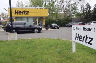 FILE - In this May 6, 2020, file photo, a Hertz car rental is closed during the coronavirus pandemic in Paramus, N.J. Two investment firms are looking to take at least a controlling stake in rental car company Hertz for up to $4.2 billion and help it emerge from bankruptcy protection. Hertz Global Holdings Inc. said Tuesday, March 2, 2021 that Knighthead Capital Management and Certares Opportunities will have the chance to buy the entire reorganized business, but no less than a majority of its shares. (AP Photo/Ted Shaffrey, File)