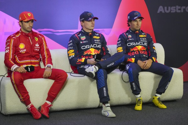 Fastest qualifier Red Bull driver Max Verstappen, centre, of the Netherlands sits with second fastest, Ferrari driver Carlos Sainz, left, of Spain and Red Bull teammate and third placed Sergio Perez of Mexico at. Press conference following the qualifying session for the Australian Formula One Grand Prix at Albert Park, in Melbourne, Australia, Saturday, March 23, 2024. (AP Photo/Scott Barbour)