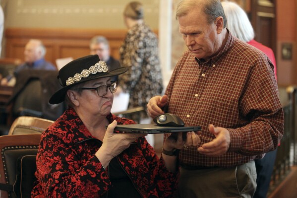 Kansas House Health and Human Services Committee Chair Brenda Landwehr, R-Wichita, left, confers with committee assistant David Long following a House vote on a bill increasing reporting requirements for abortion providers, Thursday, March 7, 2024, at the Statehouse in Topeka, Kan. The House has approved the bill, which requires providers to ask patients why they want abortions and report their answers to the state. (AP Photo/John Hanna)