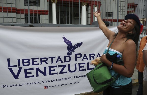 
              A Venezuelan citizen shouts slogans against Venezuelan President Nicolas Maduro outside the Venezuelan embassy on the day Maduro is sworn in for a second term, in Lima, Peru, Thursday, Jan. 10, 2019. Maduro started a new, six-year term Thursday despite international cries urging him to step down and return democratic rule to a country suffering a historic economic implosion. (AP Photo/Martin Mejia)
            