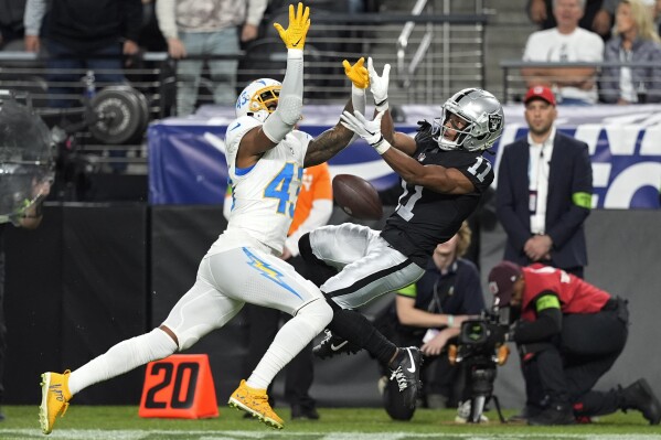 FILE - Los Angeles Chargers cornerback Michael Davis (43) breaks up a pass intended for Las Vegas Raiders wide receiver Tre Tucker (11) during the first half of an NFL football game, Thursday, Dec. 14, 2023, in Las Vegas. The Washington Commanders have signed cornerback Michael Davis to a one-year contract Monday, March 18, 2024. Davis spent his first seven NFL seasons with the Los Angeles Chargers. (AP Photo/Nick Didlick, File)