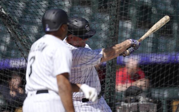 Peyton Manning and Russell Wilson take batting practice at Coors Field 