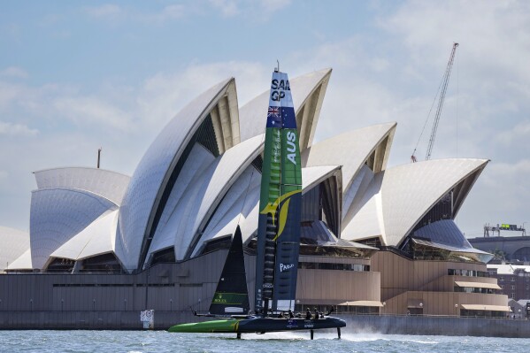 In this image provided by SailGP, Australia SailGP Team helmed by Tom Slingsby sail past the Sydney Opera House during a warm up race on Race Day 1, Australia Sail Grand Prix presented by KPMG. On Dec. 17, 2021. No pressure whatsoever, but Slingsby and his mates with Team Australia really need a win on home waters when SailGP makes its annual stop on Sydney Harbor. (Bob Martin/SailGP via AP)